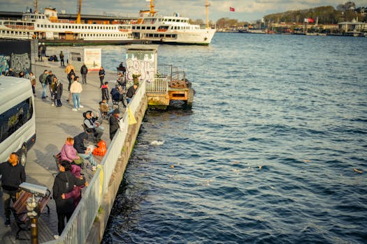 Lively waterfront scene with ferries, people strolling, and vibrant graffiti in a busy city port.